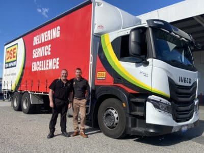 Two DSE Transport team members beside an Iveco S-Way curtain-sider at the Perth depot