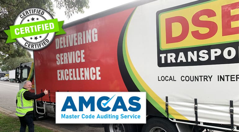 DSE Transport driver giving a thumbs up beside a curtain-sided truck, with AMCAS Master Code Auditing Service certified badges