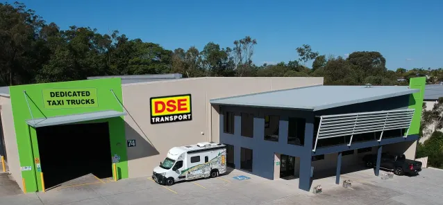 Aerial view of the DSE Transport Brisbane depot at Willawong with Dedicated Taxi Trucks signage and a DSE van parked out the front