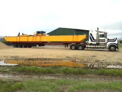 Oversize construction beam strapped down on a DSE Transport drop-deck trailer ready for delivery to site